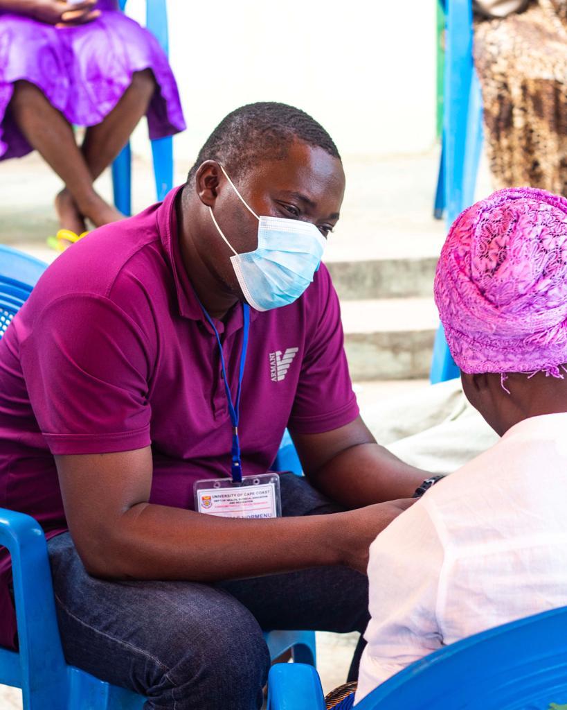A research team member consulting with a community participant